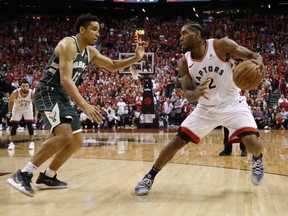 Milwaukee Bucks Malcolm Brogdon (left) guards against Toronto Raptors Kawhi Leonard in Game 3. JACK BOLAND/TORONTO SUN