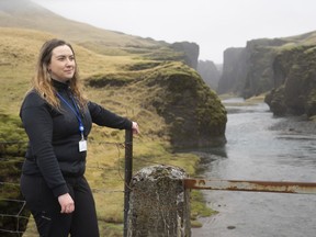 In this photo taken Wednesday, May 1, 2019, Hanna Johannsdottir, a ranger from The Environment Agency of Iceland, poses for a photograph at the mouth of the Fjadrargljufur canyon. The canyon area has suffered environmental damages after intense traffic, prompted by the music video "I'll Show You" by Justin Bieber.