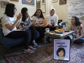 Atiya Jaffa, (left to right) Narissa Diwan, Urooba Jamal, Rauza Khan and Cait Murphy exchange ideas for actions to draw attention to the imprisonment of Loujain al-Hathloul in a Saudi Arabian prison. Photo: Gerry Kahrmann/Postmedia