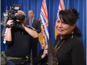 CeeJai Julian cries as Commissioner Wally Oppal (background) delivers the final report of the Missing Women Inquiry in Vancouver in 2012.