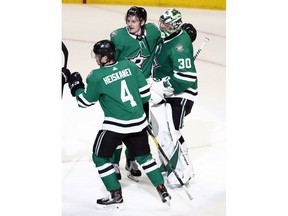 Dallas Stars goaltender Ben Bishop (30) celebrates with teammates Roope Hintz and Miro Heiskanen (4) after the Stars defeated the St. Louis Blues 4-2 in Game 4 of an NHL second-round hockey playoff series, Wednesday, May 1, 2019, in Dallas.