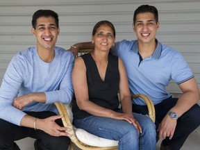 Jas Hans (left) and his twin brother Paul with their mother Kulwant at their Surrey home. Photo: Gerry Kahrmann/Postmedia