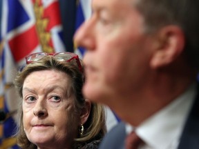 Chair of the expert panel Maureen Maloney looks on as Former Mountie Peter German answers questions from media about details found in a recent report during a press conference at Legislature in Victoria, B.C., on Thursday, May 9, 2019. Photo: Chad Hipolito, CP