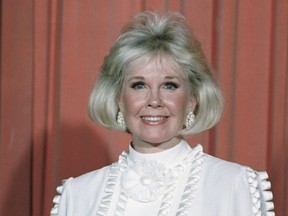 In this Jan. 28, 1989 file photo, actress and animal rights activist Doris Day poses for photos after receiving the Cecil B. DeMille Award she was presented with at the annual Golden Globe Awards ceremony in Los Angeles. Day, whose wholesome screen presence stood for a time of innocence in '60s films, has died, her foundation says. She was 97. The Doris Day Animal Foundation confirmed Day died early Monday, May 13, 2019, at her Carmel Valley, California, home. (AP Photo, File) ORG XMIT: NYCD901