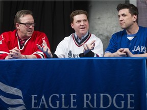 Before a Pat-cast live recording at Woody's Pub in Coquitlam last April, Ed Willes, left, Jeff Paterson and Jason Botchford, right, talk hockey with pub patrons. Botchford died this weekend at age 48.