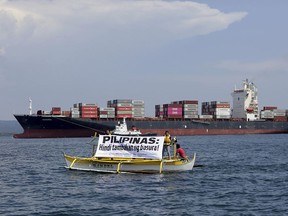 In this image released by Greenpeace, Greenpeace activists and other environmental groups display a banner as the cargo ship MV Bavaria, the container vessel allegedly hired to ship back the 69 containers loaded with garbage from Canada, slowly enters the mouth of Subic Bay on May 30 in the Philippines. The environmental groups are calling on the Philippine government to ban all waste imports into the country and ratify the Basel Ban Amendment. The banner reads: 'Philippines Is Not Aa Dumpsite!'