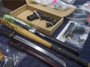 Law enforcement in British Columbia report the gang landscape in the province is unlike any other because so many members are joining from the middle and upper classes. Guns seized in anti-gang operation shown.