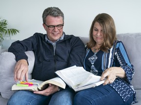 Kevin and Julia Garratt flip through the Bibles they had while jailed in China.