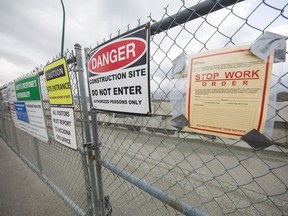 Stop work order at the gate to the construction site.