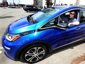 Travis McKeown sits in his new, Blue Chevy Bolt in Richmond on May 6 as range-anxiety, a lack of charging stations, the high cost of battery replacements, rural preference for heavy vehicles and more are concerns during debate of a government bill to ban gas vehicles by 2040 and mandate electric-only vehicles.
