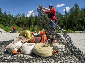 Scott Parkinson is a firefighter training for possible fires at or near Metro Vancouver's watersheds and regional parks. Here he prepares equipment. Photo: Arlen Redekop, Postmedia