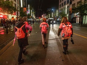 Members of the Good Night Out Vancouver Street Team patrol on  Granville Street.