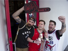 General Manager of the Red Card Sports Bar and Eatery, Matt Kittle  ( R ), along with Evan Morse ( L ) and Trevor Kennedy ( C ) show their enthusiasm for the Raptors being in the NBA final.