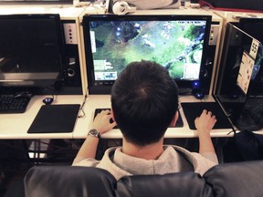 In this file photo, a college student plays a computer game at an Internet cafe in South Korea. A new UBC report links gambling and loot boxes.