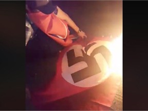 A man who goes by the name Caleb Beaudin on Facebook, says he did what the law wouldn't when he took down a pair of swastika and Confederate flags from outside a Keliher home early Saturday morning and burned them. Screen shot taken from Facebook video.