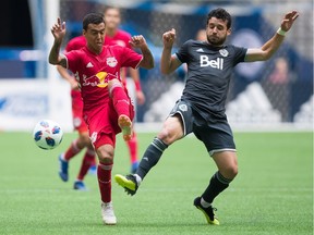 The Whitecaps' Felipe (right) and the New York Red Bulls' Alejandro Gamarra vie for the ball during their August 2018 MLS match at B.C. Place Stadium.