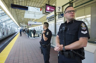 Transit Police Sgt. Clint Hampton and Const. Darren Chua on the platform at the Surrey Central Skytrain station.