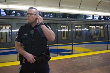 Transit Police Sgt. Clint Hampton listens to his radio after a train stopped at the Gateway station when an intrusion alarm stopped the train.