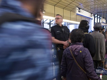 Transit Police Sgt. Clint Hampton on the platform of the Surrey Central SkyTrain station as a train empties out.
