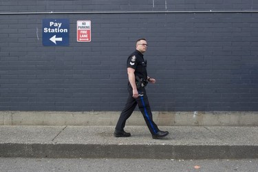 Transit Police Sgt. Clint Hampton checks out a parking lot across the street from Surrey Central station.