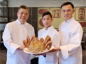 From left, chefs Tony Mah, John Deng and Kent Wong of the Western Lake Chinese Seafood Restaurant with a king crab.