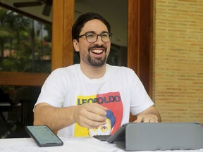 In this Saturday, May 11, 2019 photo, Venezuelan opposition leader Freddy Guevara, exiled at the Chilean ambassador's residence, smiles during an interview with The Associated Press, in Caracas, Venezuela. Guevara, in his first televised interview since taking refuge in the lush diplomatic compound 18 months ago, said as foreign embassies in Caracas fill up with dissidents the world will be forced to take notice of how Nicolas Maduro's clinging to power is not only inflicting more damage on what's left of the rule of law in Venezuela but spilling over its borders as well.