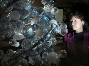 Karen Burke, director of regulatory affairs at Amgen Canada, poses with a glass installation model of a complex molecule, at the biosciences Canadian head office in Mississauga.