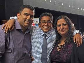 Mohnish Peshin, 12, (centre) and his father, Deepak Peshin, and mother, Suman Tiku, attend an event at Surrey City Hall to mark World Elder Abuse Awareness Day.