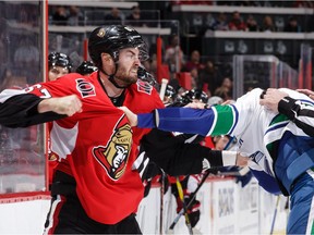 Ben Harpur of the Ottawa Senators throws a punch at Tim Schaller.