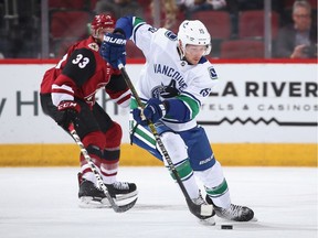 Ryan Spooner of the Vancouver Canucks carries the puck with Arizona Coyote Alex Goligoski in pursuit during their Feb. 28, 2019 NHL game at Gila River Arena in Glendale, Ariz.