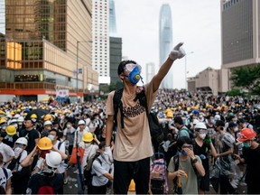 A protester makes a gesture during a protest this week in Hong Kong. Large crowds of protesters gathered in central Hong Kong as the city braced for another mass rally in a show of strength against the government over a divisive plan to allow extraditions to China.