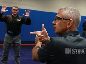 VPD Media demonstration on training for use of force. Retired Sgt. and instructor Clive Milligan demonstrates and talks about the use of a gun as Sgt. John Roberts plays the suspect.