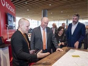Premier John Horgan (second from left), Minster Jinny Simms (third left) and Rogers CTO Jorge Fernandes (far right) get a demo on how 5G will enhance smart city planning at the B.C. Tech Summit in Vancouver.