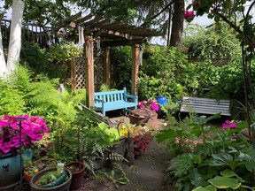 Sitting area in a secluded backyard.  One of the 'rooms' of this garden that features scented plants and owner-designed hardscapes and wood projects. Photo credit:  East Vancouver Garden Tour.
