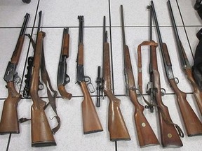 A Chilliwack man has been charged after 10 rifles and shotguns were seized during a pair of police searches earlier this month. This Chilliwack RCMP handout photo shows the rifles seized.