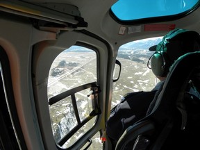 RCMP officers monitor a highway below. Supplied