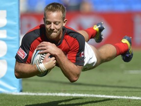 Harry Jones of Canada dives over to score a try during the Gold Coast Sevens Shield semifinal match between Canada and Scotland at Skilled Stadium on Oct. 13, 2013 on the Gold Coast, Australia.