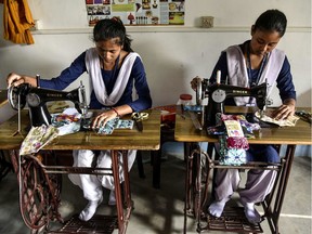 Indian students of the school for underprivileged children, Parijat Academy, make reusable cloth sanitary napkins on the Menstrual Hygiene Day in Guwahati on May 28, 2019. - The Menstrual Hygiene Day, marked on May 28, raises awareness about the importance of managing good menstrual hygiene for every woman and girl.