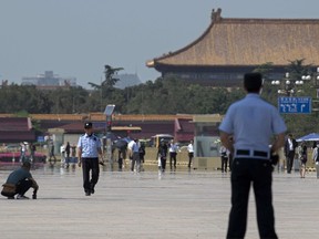 Police officers patrol and secure Tiananmen Square in Beijing on June 3, 2019.