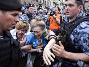 Russian police officers detain protesters during a march to protest the arrest of investigative journalist Ivan Golunov. He was released.