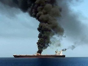 A picture obtained by AFP from Iranian State TV IRIB on June 13, 2019 reportedly shows smoke billowing from a tanker said to have been attacked off the coast of Oman, at un undisclosed location.