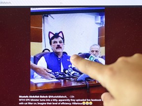 Pakistani children point at a computer screen showing a screen grab of a press conference attended by provincial minister Shaukat Yousafzai and streamed live on social media, in Islamabad on June 15, 2019.