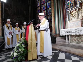 The Notre-Dame de Paris cathedral's rector Patrick Chauvet, speaks during the first mass in a side chapel two months to the day after a devastating fire engulfed the Notre-Dame de Paris cathedral.