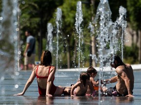 People cool off in water fountains at Parc Central amid a heatwave in Valencia. Spain was hit by more wildfires as temperatures remained sky-high in the Europe-wide heatwave, authorities said, just as firefighters finally managed to contain another blaze they had been tackling for nearly 72 hours.