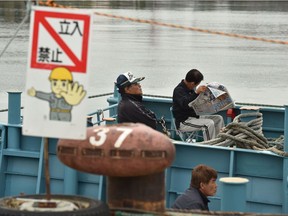 Japanese fishermen on their whaling ships wait for departure at a port in Kushiro, Hokkaido Prefecture on July 1, 2019. - Japanese fishermen set sail on July 1 to hunt whales commercially for the first time in more than three decades after Tokyo's controversial withdrawal from the International Whaling Commission (IWC) triggered outrage from environmental groups.