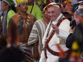 Pope Francis, wearing gifts, leaves after a meeting with representatives of indigenous communities of the Amazon basin from Peru, Brazil and Bolivia, in the Peruvian city of Puerto Maldonado, on January 19, 2018.