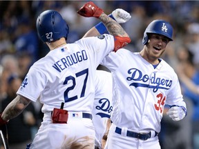 Cody Bellinger of the Los Angeles Dodgers is greeted by centrefielder Alex Verdugo after hitting a two-run home run against the San Francisco Giants this week at Dodger Stadium.
