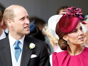 Prince William and Kate, Duchess of Cambridge, look up at the Royal Standard flying from the round tower following the wedding of Princess Eugenie of York and Jack Brooksbank in St George's Chapel, Windsor Castle, near London, Britain October 12, 2018.