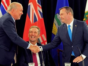 Alberta Premier Jason Kenney shakes hands with British Columbia Premier John Horgan at the closing of the Premiers' Conference in Edmonton, Alberta, Canada, June 27, 2019.