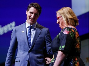 Prime Minister Justin Trudeau smiles at Women Deliver president and CEO Katja Iversen as he prepares to make remarks during the opening of the Women Deliver 2019 Conference at the Vancouver Convention Centre on June 3.